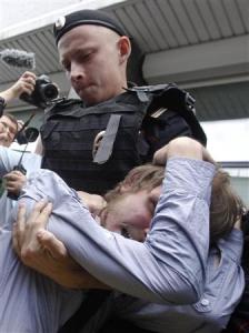 A policeman detains a gay rights activist during a protest against a proposed new law termed by the State Duma as "against advocating the rejection of traditional family values" in central Moscow