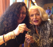 Melanie Nathan giving a Nelson Mandela coin to Edie Windsor.
